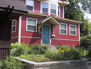 A red house with a blue door and windows.