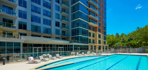 a swimming pool in front of a tall building