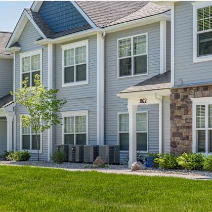 a row of townhouses with grass in front of them