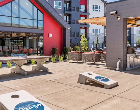 Arazo outdoor game area with table tennis, sandbags and a grilling station