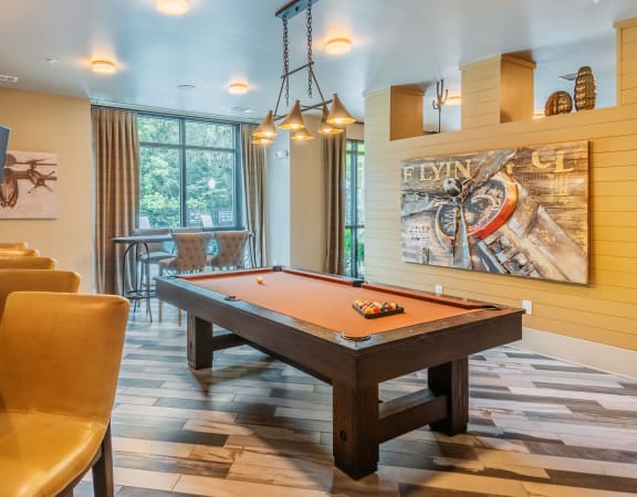 Centre Pointe Apartments game room with a billiards table and bar seating