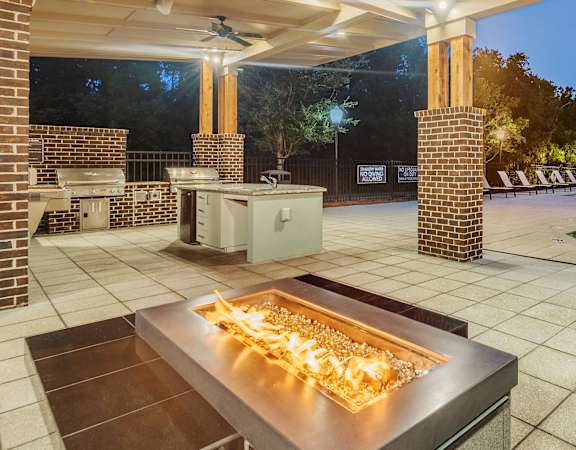 Centre Pointe Apartments outdoor fire pit area with BBQ grills