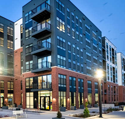 an exterior view of an apartment building at dusk