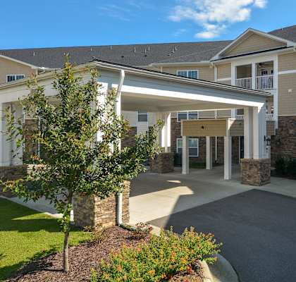 the view of the entrance to a building with a covered porch