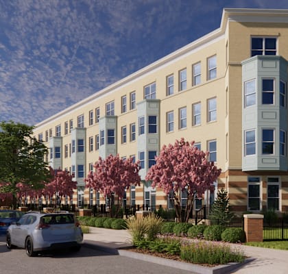 A modern building with a row of trees in front of it.