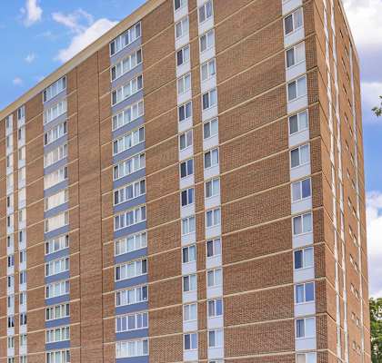 A tall brick building with many windows. at Ashton Heights Apartments, Suitland, MD
