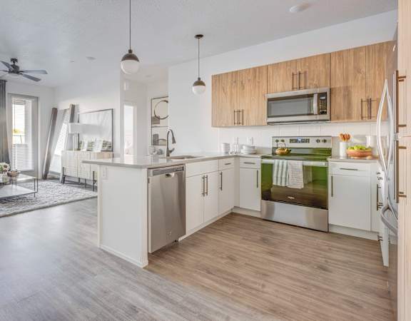 A modern kitchen with wooden cabinets and stainless steel appliances.