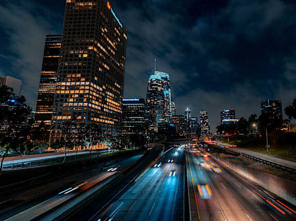 a city at night with traffic on a highway
