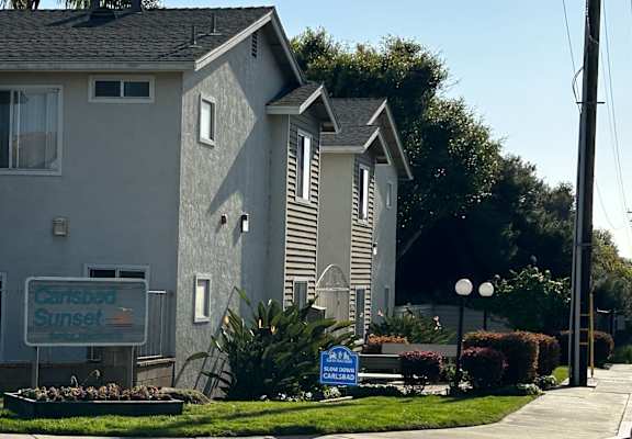 a gray house with a sign that reads garfield sunset