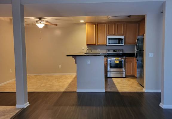 a kitchen with an island and stainless steel appliances