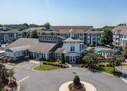 an aerial view of a large building with a swimming pool
