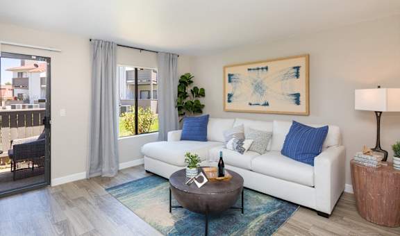 a living room with a white couch and a coffee table