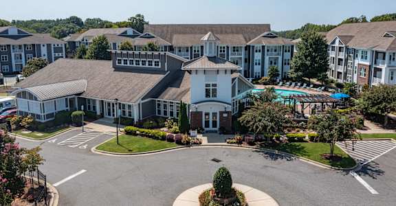 an aerial view of a large building with a swimming pool
