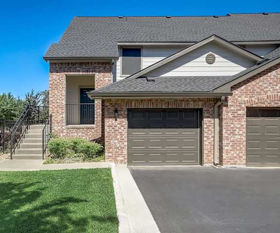 a house with a driveway and a garage door in front of it at The Vista on Brodie, Austin