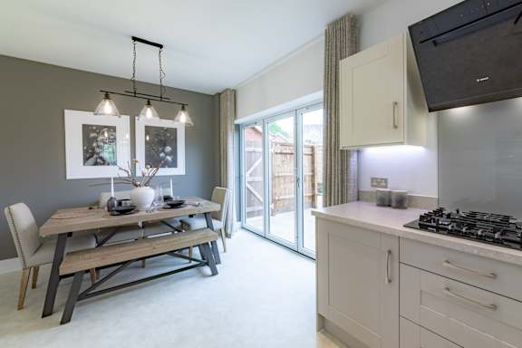 A modern kitchen with a dining table and chairs.