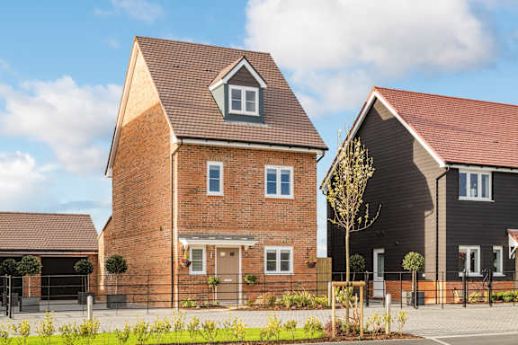 A modern house with a brick facade and a dark grey one.