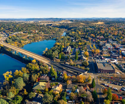 A beautiful aerial view of a small town with a river running through it.