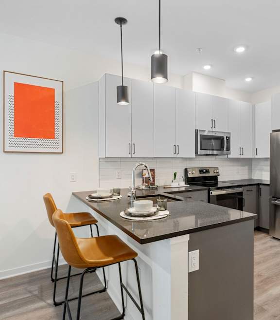 A kitchen with a table and chairs and a fridge.at 829 Garfield, Jersey City