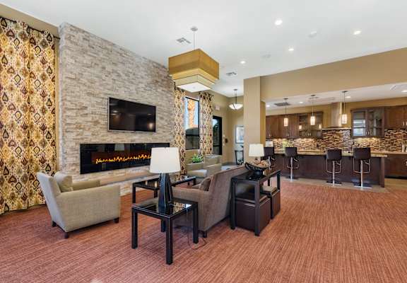 a living room with a fireplace and a table with chairs