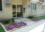 Thumbnail 9 of 17 - Shoreview Apartments leasing office exterior entryway with landscaping