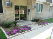 Thumbnail 9 of 17 - Shoreview Apartments leasing office exterior entryway with landscaping