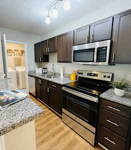 A kitchen with granite countertops and stainless steel appliances.