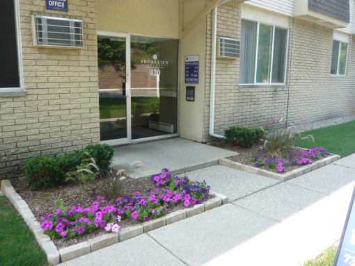 Shoreview Apartments leasing office exterior entryway with landscaping