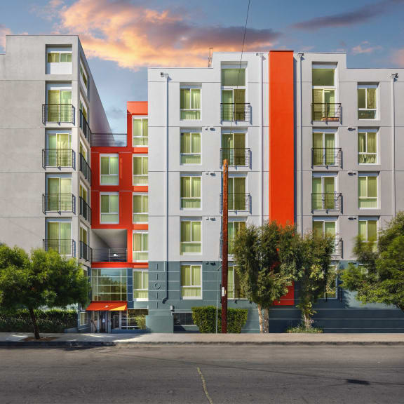 the lobby with red wall and red couches at The Social Apartments, CA, 91601