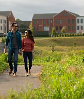 A man and a woman are walking on a path.