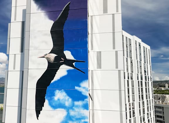 A large image of a bird on a building.