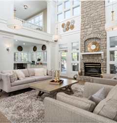 a white living room with couches and a table