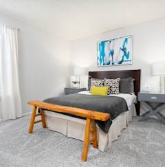 a bedroom with a bed and a large window