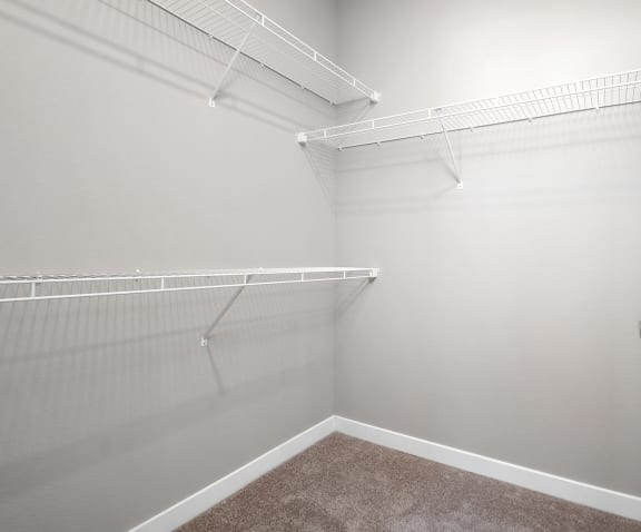 an empty closet with white walls and a white door  at Aventura at Richmond, Missouri