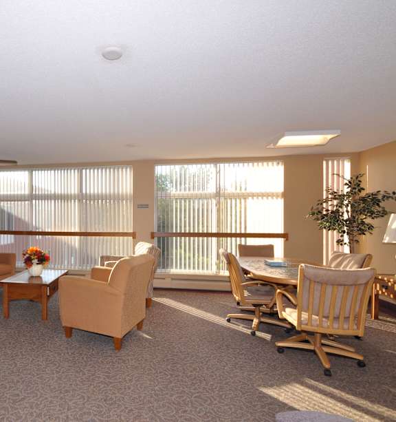 A living room with a couch, chairs, and a coffee table.