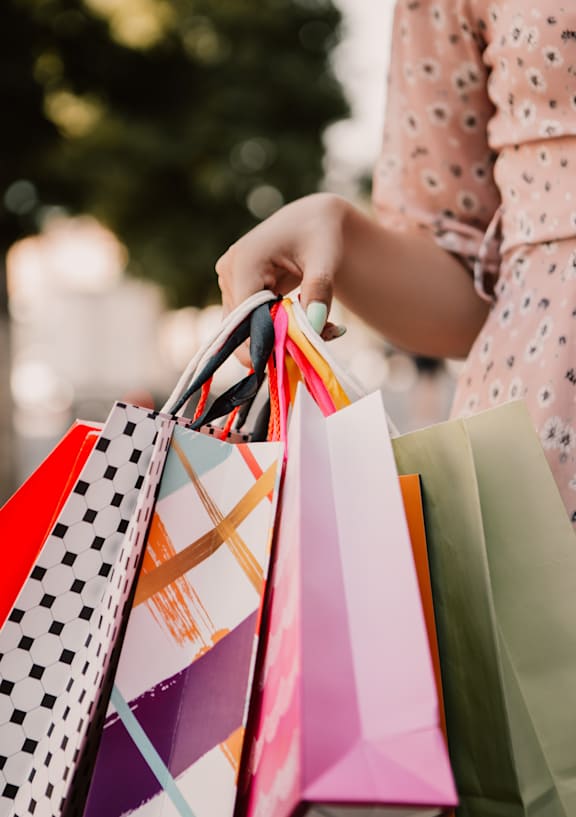 A person holding shopping bags in their hand.