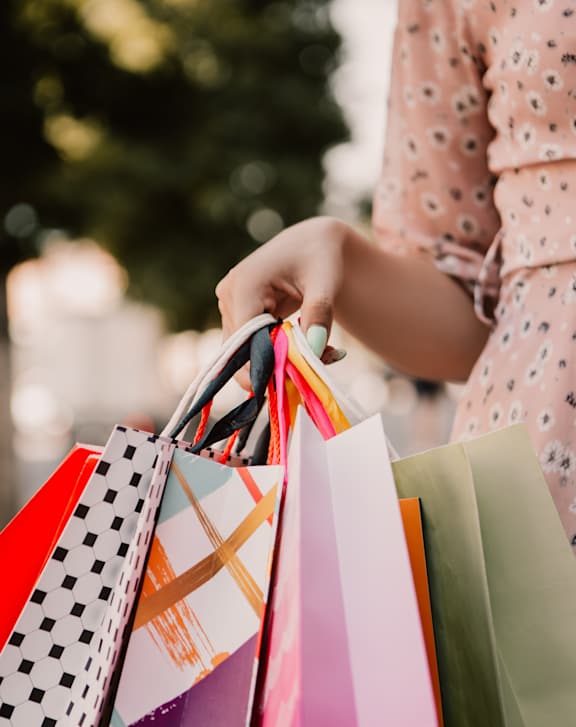 A person holding shopping bags in their hand.