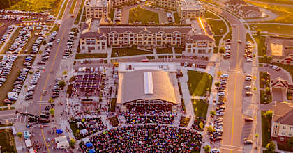 an aerial view of a large crowd in a parking lot