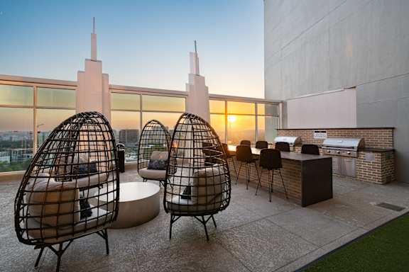 a living area with chairs and a table and a view of the city
