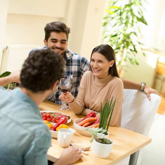 Young people sitting at the table at The Residences at The Gilmore in Gilbert, AZ
