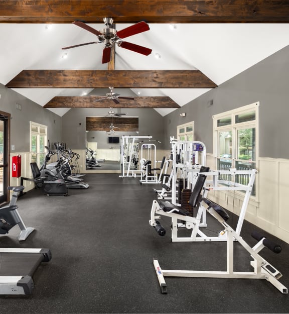 the gym with treadmills and weights at the enclave at woodbridge apartments