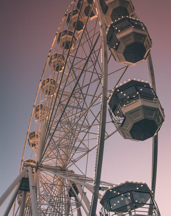 a ferris wheel with a purple sky in the background