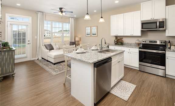 a kitchen with an island and a living room with a couch