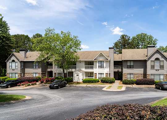 A large building with a parking lot in front of it.