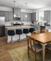 an open kitchen and dining room with a table and chairs