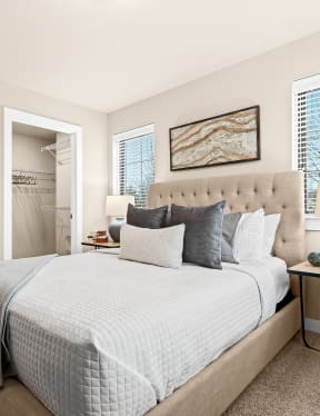 a bedroom with a large bed and a door to a closet