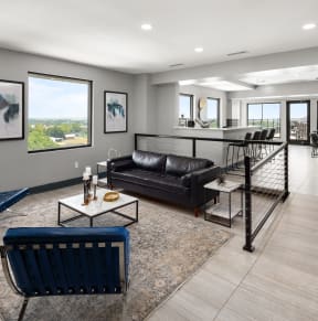 a living room filled with furniture and a large window