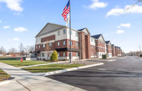 a flag pole with an flag in front of a building