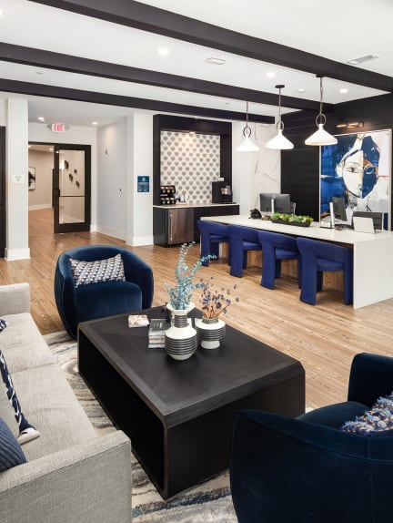 a living room and dining room with blue chairs and a table