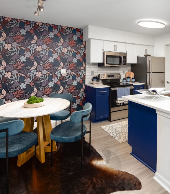a white kitchen with blue cabinets and a white counter top