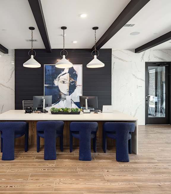 a dining room with a large table and blue chairs